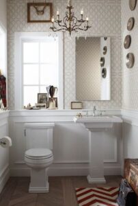 bathrooms - Kohler Tresham Pedestal Sink red white zigzag chevron rug herringbone wood floors white pedestal sink wainscoting beige wallpaper bronze crystal chandelier