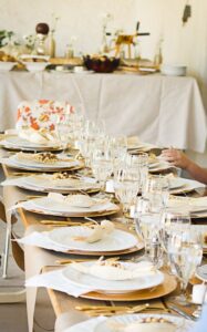 Rustic elegant Thanksgiving dinner. Gold and white with corn husks.